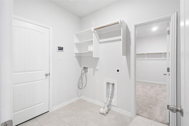 washroom with electric dryer hookup, light tile patterned floors, and hookup for a gas dryer