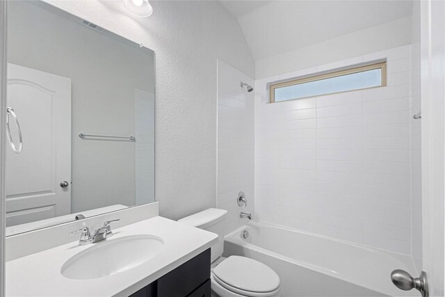 full bathroom with shower / bathtub combination, toilet, vanity, and lofted ceiling