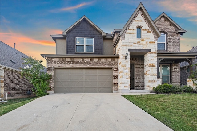 view of front of house featuring a garage and a yard