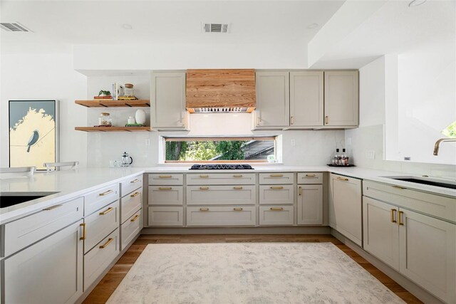 kitchen with plenty of natural light, white dishwasher, sink, and light wood-type flooring