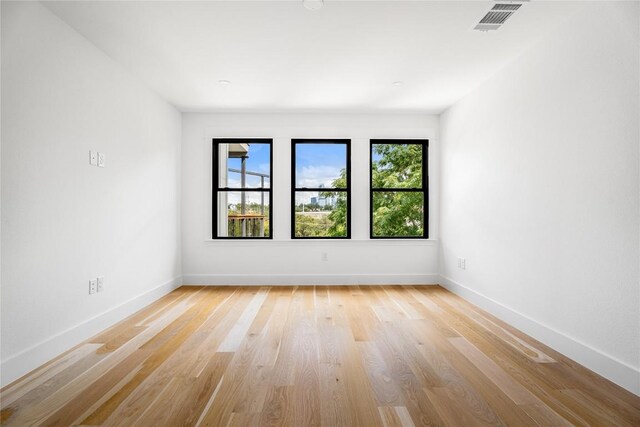 unfurnished room with light hardwood / wood-style flooring