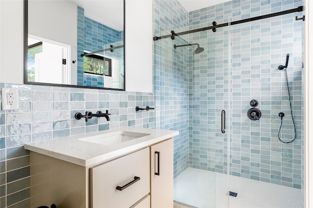 bathroom featuring vanity, tile walls, and a shower with shower door