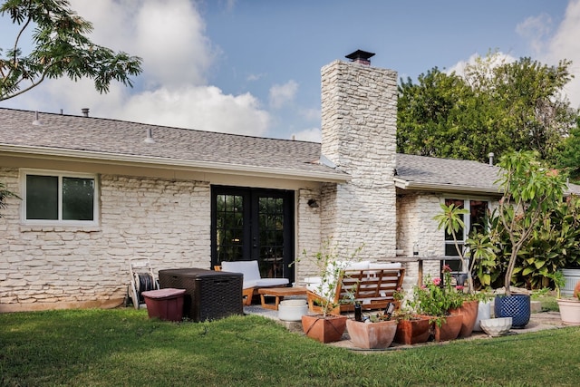 rear view of property featuring french doors and a yard