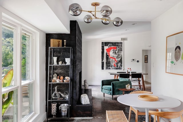 dining space featuring an inviting chandelier and vaulted ceiling