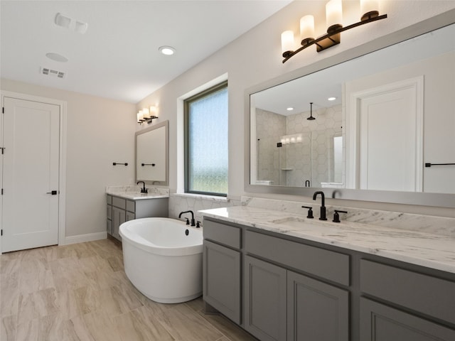 bathroom with tile patterned flooring, plus walk in shower, and vanity