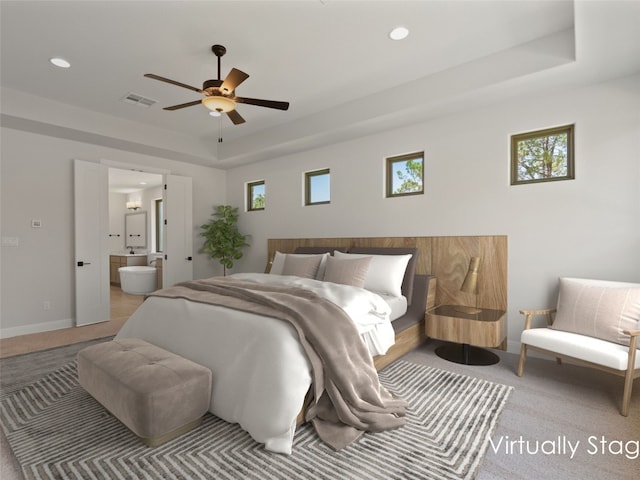 bedroom featuring ceiling fan, carpet, ensuite bathroom, and multiple windows