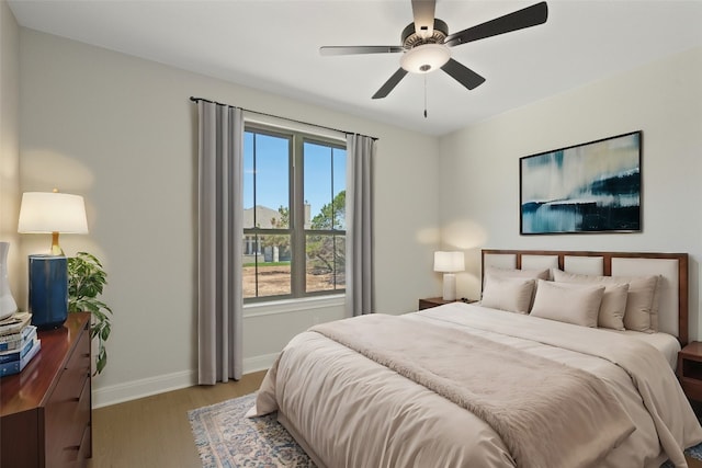 bedroom with ceiling fan and light hardwood / wood-style floors