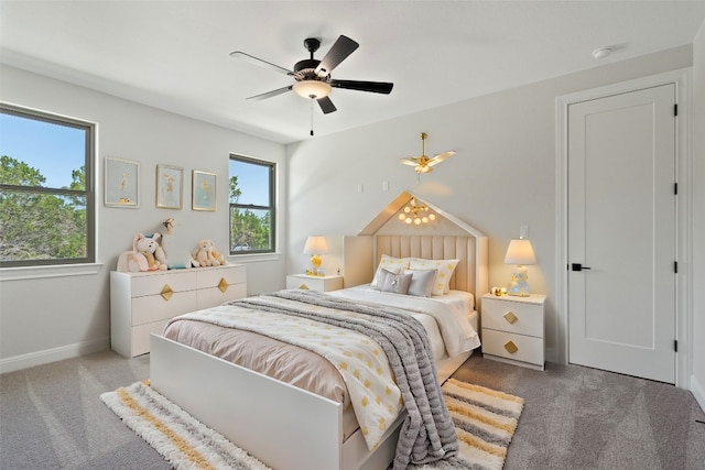 carpeted bedroom featuring ceiling fan and multiple windows