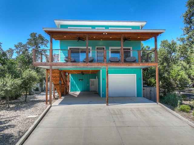 contemporary house with a carport, a garage, and ceiling fan