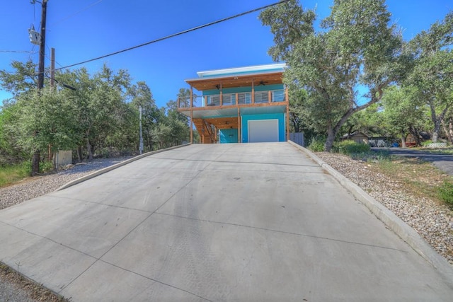 view of front facade with a garage and a balcony