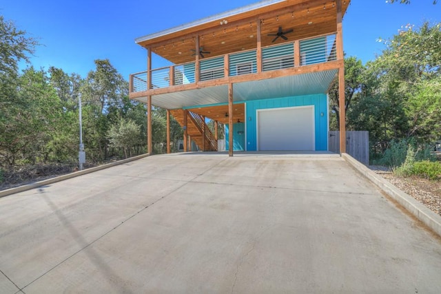 exterior space with ceiling fan and a garage