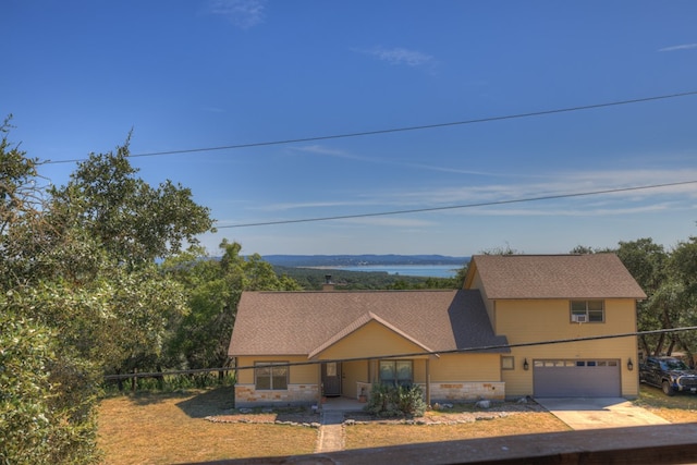 view of front facade with a water view and a garage