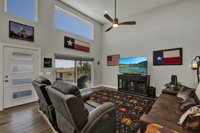 living room featuring dark hardwood / wood-style floors, high vaulted ceiling, and ceiling fan