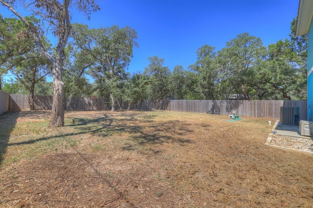 view of yard featuring central AC unit and a fenced backyard