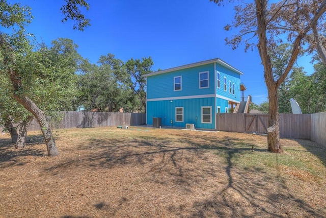 back of house with a fenced backyard