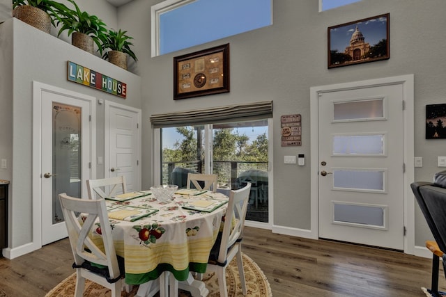 dining space with wood-type flooring