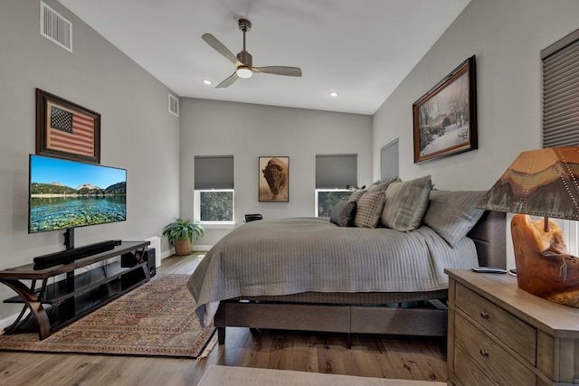 bedroom with wood-type flooring, ceiling fan, and lofted ceiling