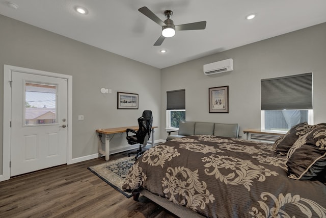 bedroom with multiple windows, ceiling fan, dark hardwood / wood-style flooring, and a wall mounted air conditioner