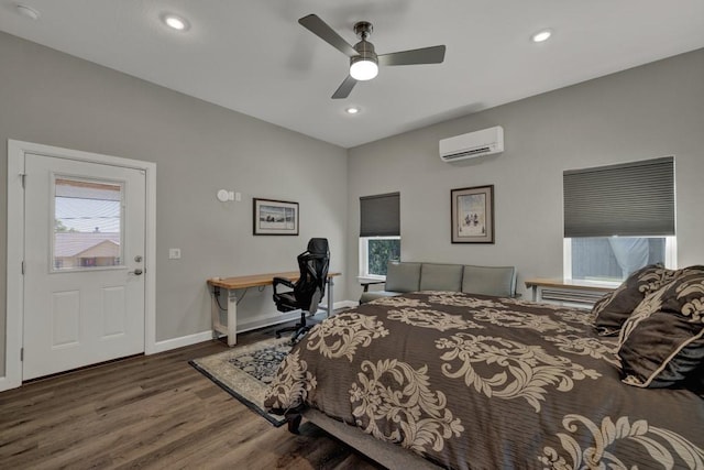 bedroom with baseboards, recessed lighting, wood finished floors, and a wall unit AC