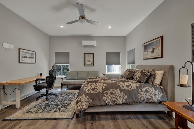 bedroom featuring recessed lighting, a wall mounted AC, baseboards, and wood finished floors