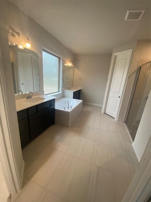 bathroom with vanity, tile patterned flooring, and shower with separate bathtub