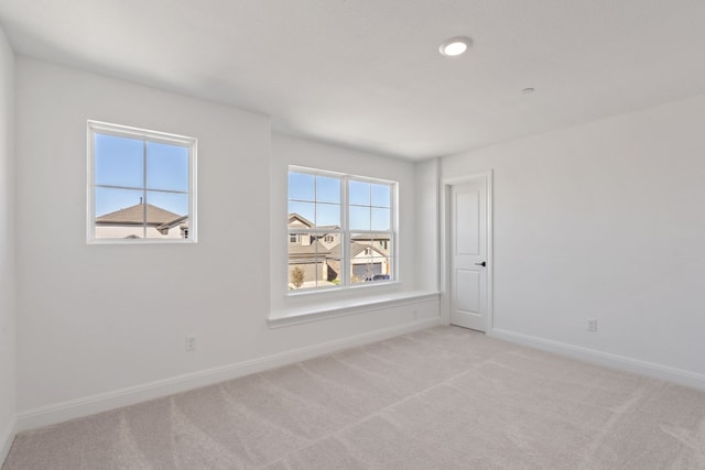 carpeted empty room with a healthy amount of sunlight