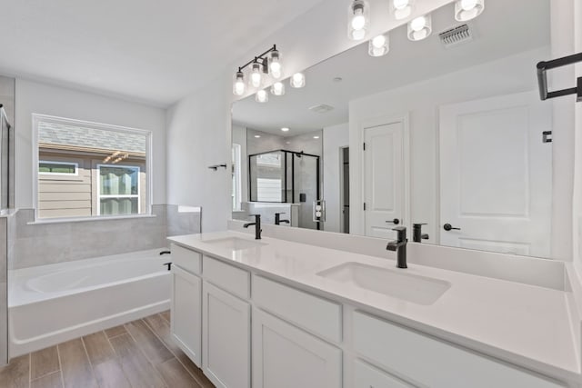 bathroom with vanity and separate shower and tub