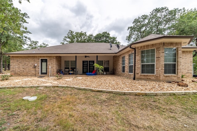 rear view of house featuring a patio area and a yard