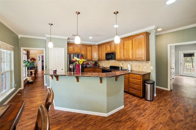 kitchen with backsplash, a center island, ornamental molding, dark hardwood / wood-style floors, and black appliances