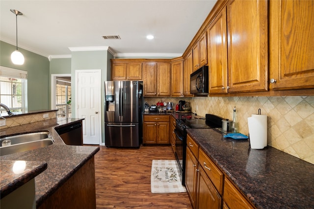 kitchen featuring backsplash, sink, ornamental molding, dark wood-type flooring, and black appliances