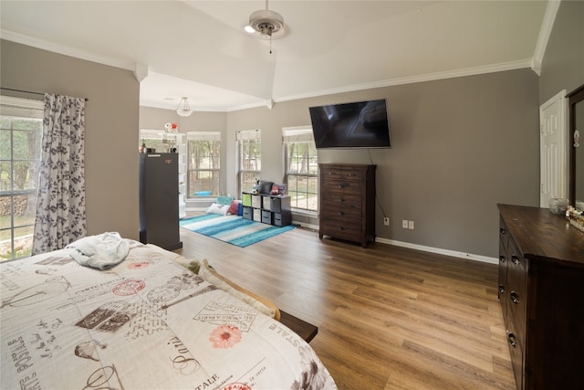 bedroom featuring ceiling fan, wood-type flooring, and ornamental molding