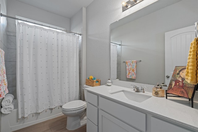 full bathroom with hardwood / wood-style flooring, shower / bath combination with curtain, vanity, and toilet