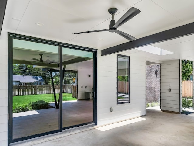 exterior space with ceiling fan, plenty of natural light, and concrete flooring