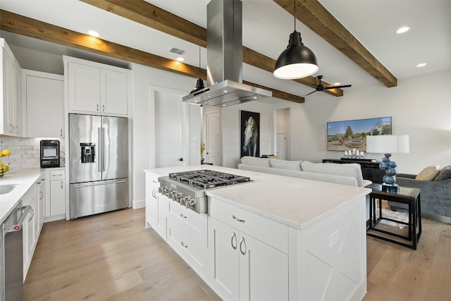 kitchen featuring stainless steel appliances, island range hood, light wood-type flooring, and beam ceiling