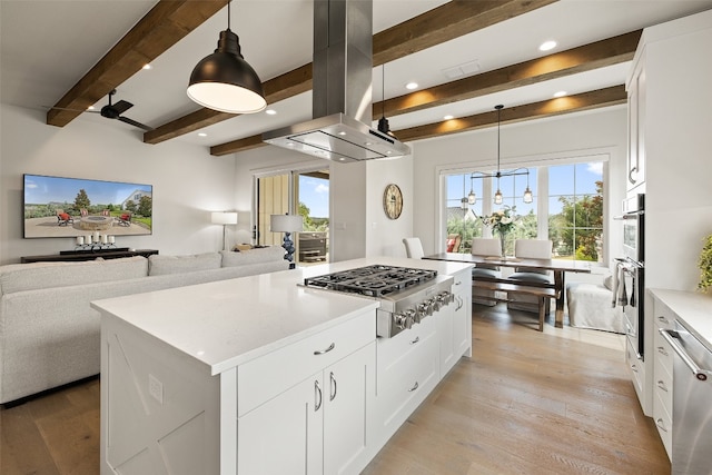 kitchen featuring decorative light fixtures, light hardwood / wood-style floors, island range hood, beamed ceiling, and a kitchen island