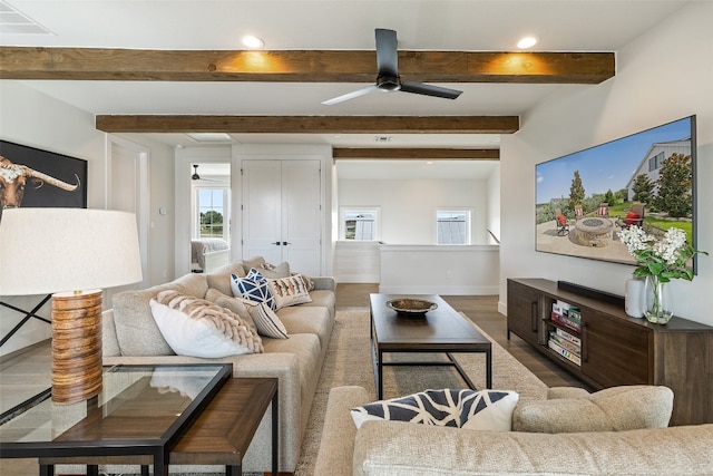 living room with ceiling fan, beam ceiling, and hardwood / wood-style flooring