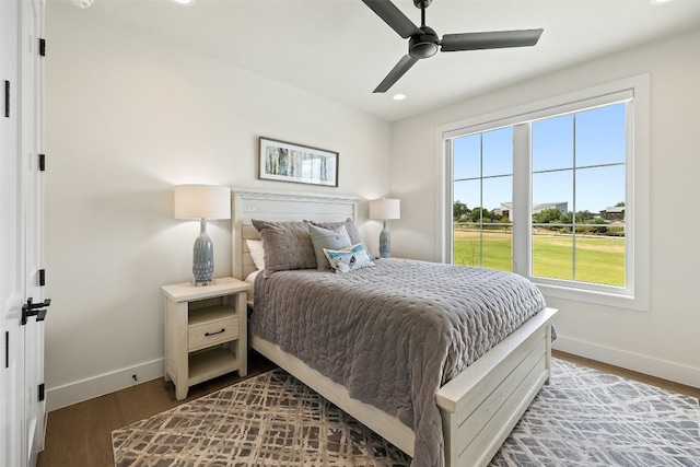 bedroom with ceiling fan and dark wood-type flooring