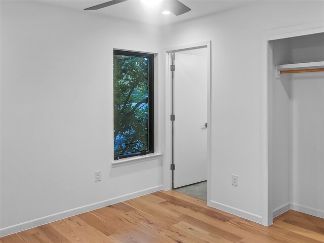 unfurnished bedroom with light hardwood / wood-style floors and ceiling fan