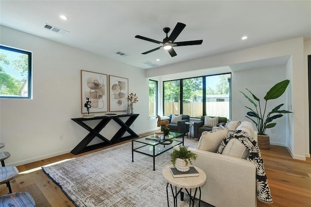 living room with ceiling fan and hardwood / wood-style floors