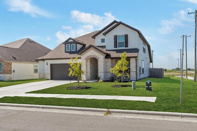 view of front of house with a garage and a front lawn