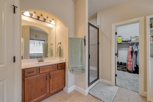 bathroom with vanity, tile patterned flooring, and a shower with shower door