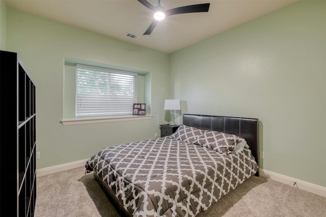 bedroom with ceiling fan and light colored carpet