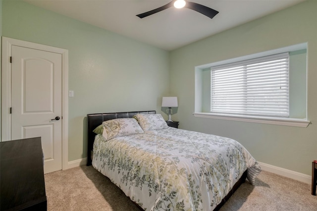 bedroom featuring ceiling fan and light carpet