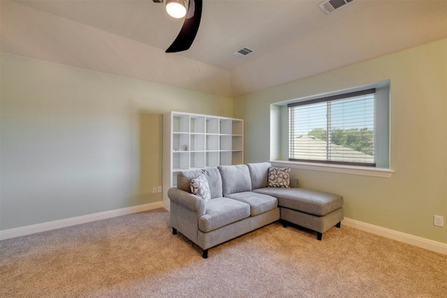 living area featuring vaulted ceiling, ceiling fan, and light carpet