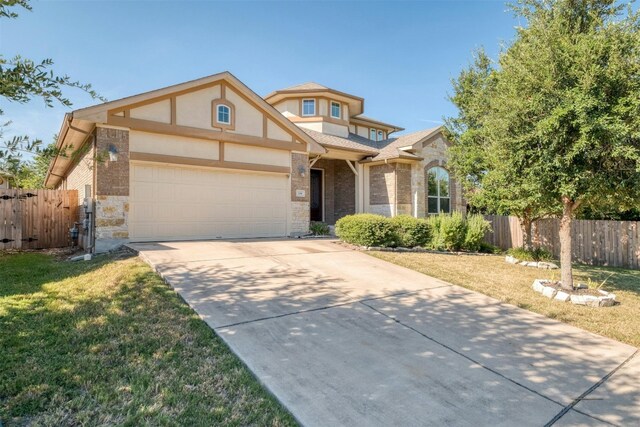 view of front of property with a garage and a front lawn