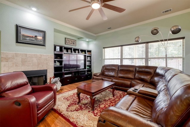 living room featuring ornamental molding, ceiling fan, and hardwood / wood-style floors