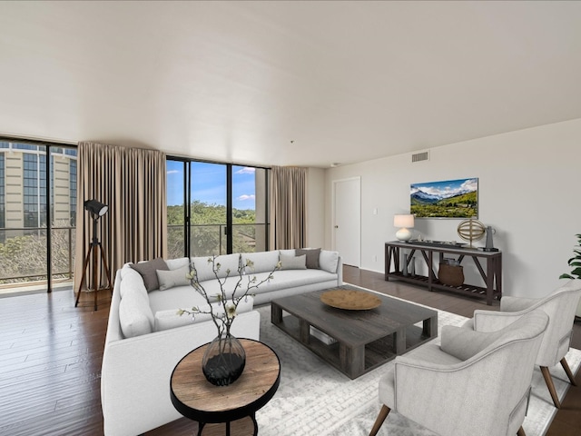 living room with floor to ceiling windows and wood-type flooring