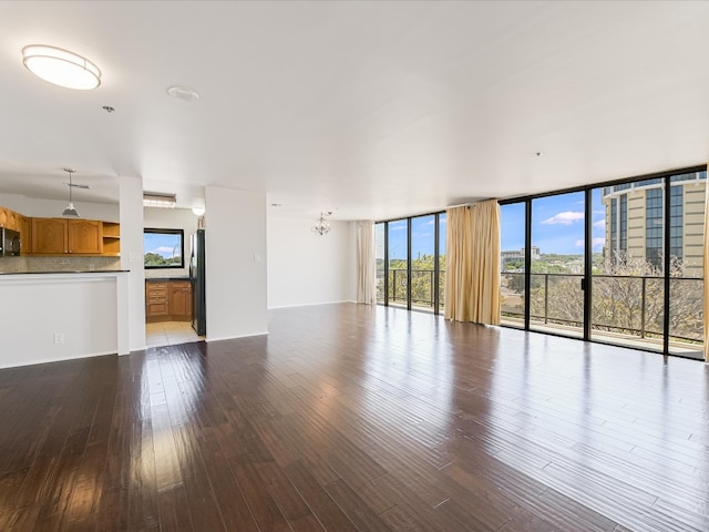 unfurnished living room featuring hardwood / wood-style floors and expansive windows