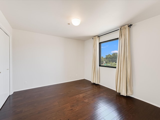 empty room with hardwood / wood-style floors