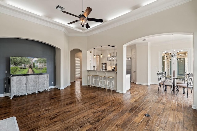 living room with ceiling fan with notable chandelier, dark wood finished floors, visible vents, and baseboards